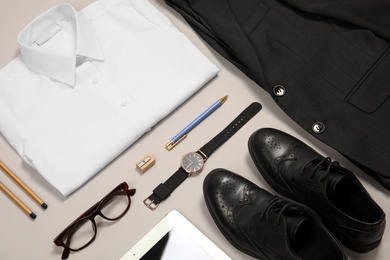 Photo of School uniform for boy and stationery on grey background