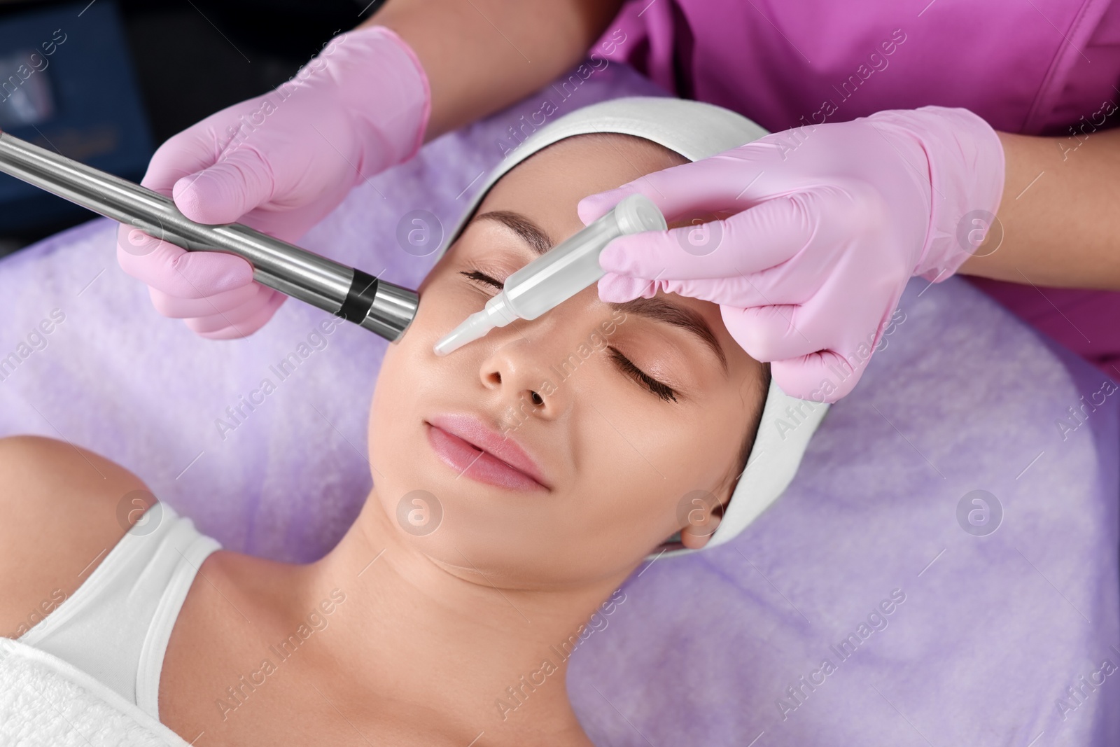 Photo of Young woman undergoing cosmetic procedure in beauty salon. Microcurrent therapy