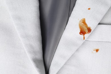 Photo of Dirty jacket with stains of sauce, top view