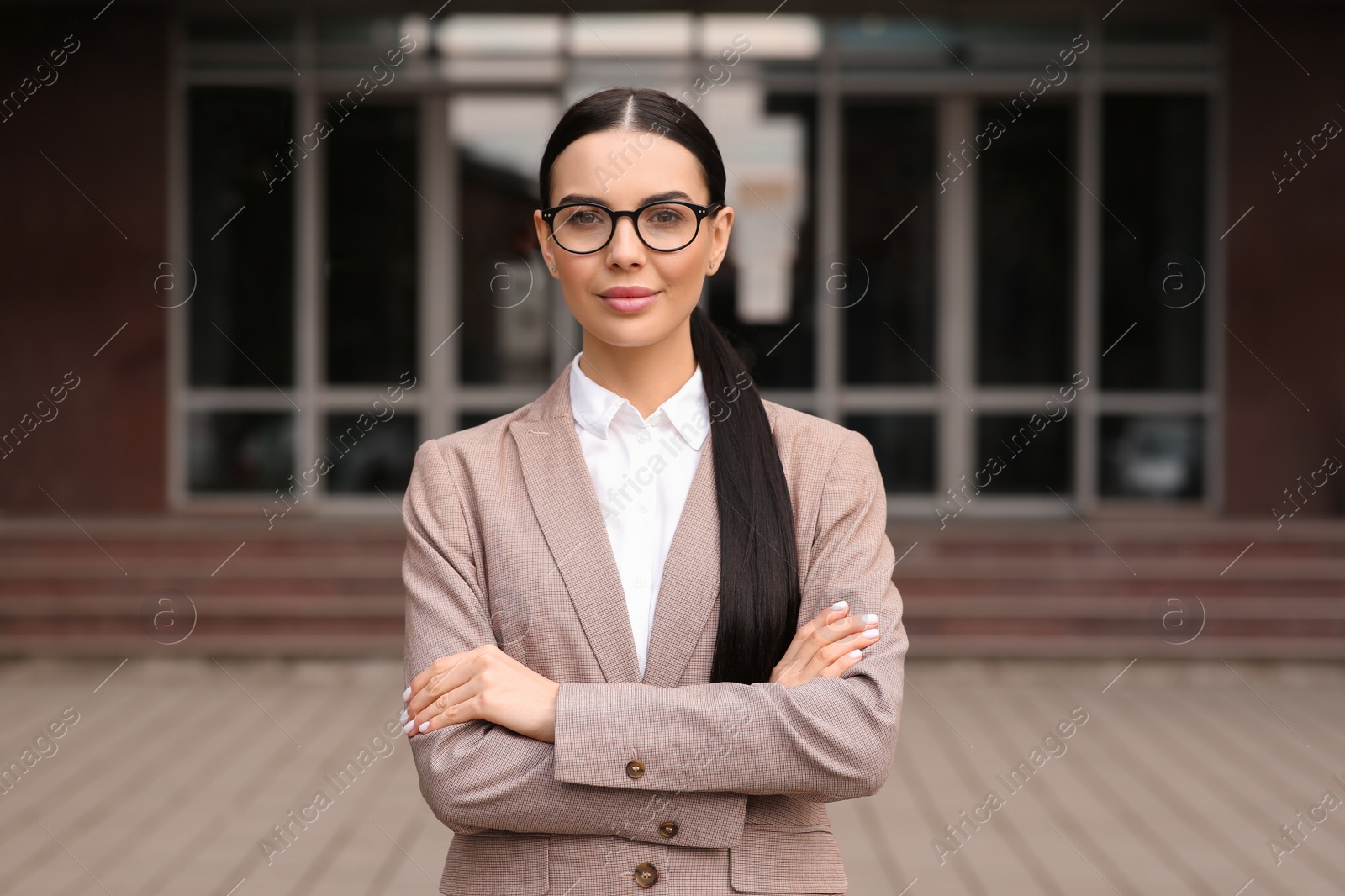 Photo of Beautiful real estate agent in nice suit outdoors