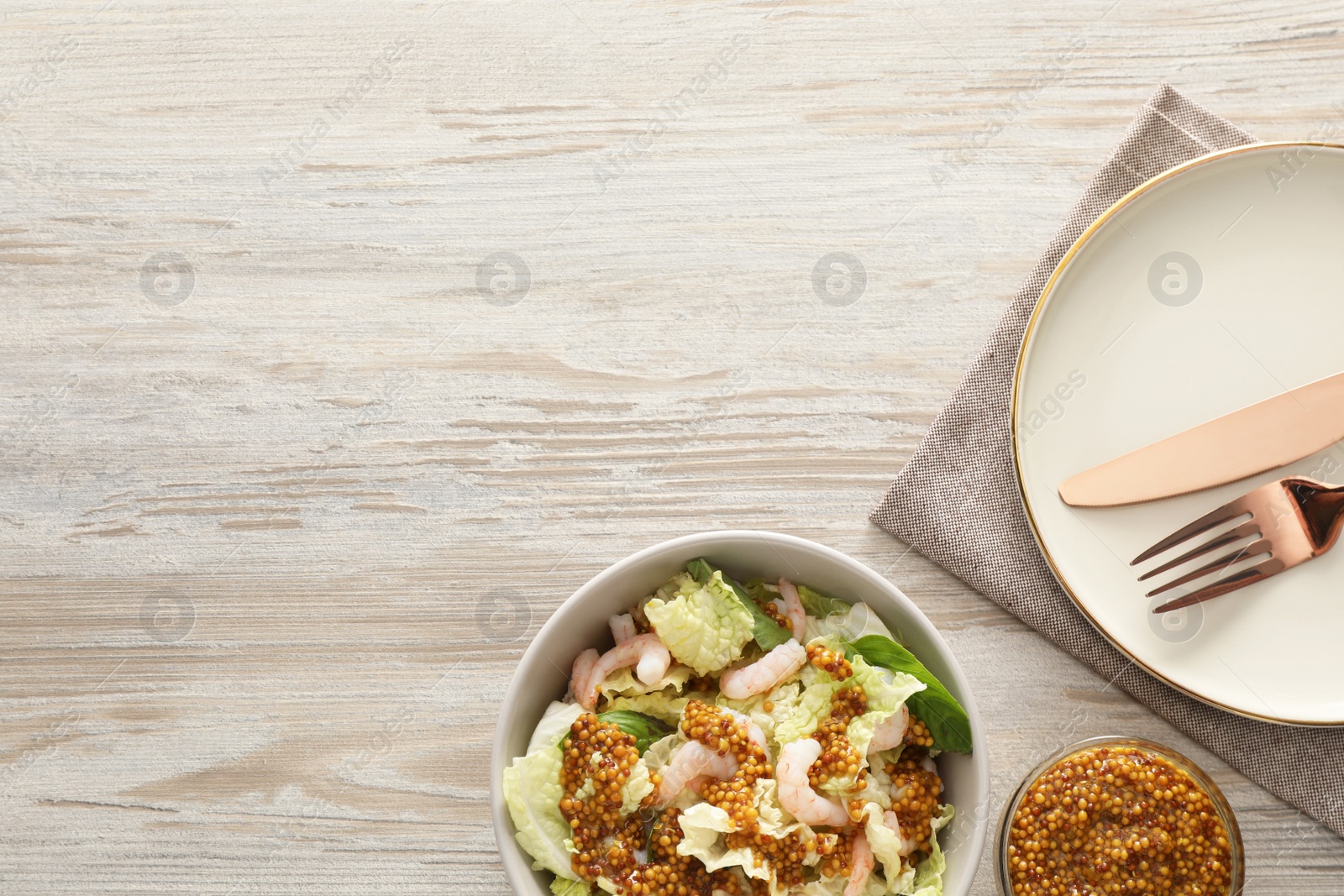 Photo of Delicious salad with Chinese cabbage, shrimps and mustard seed dressing served on white wooden table, flat lay. Space for text