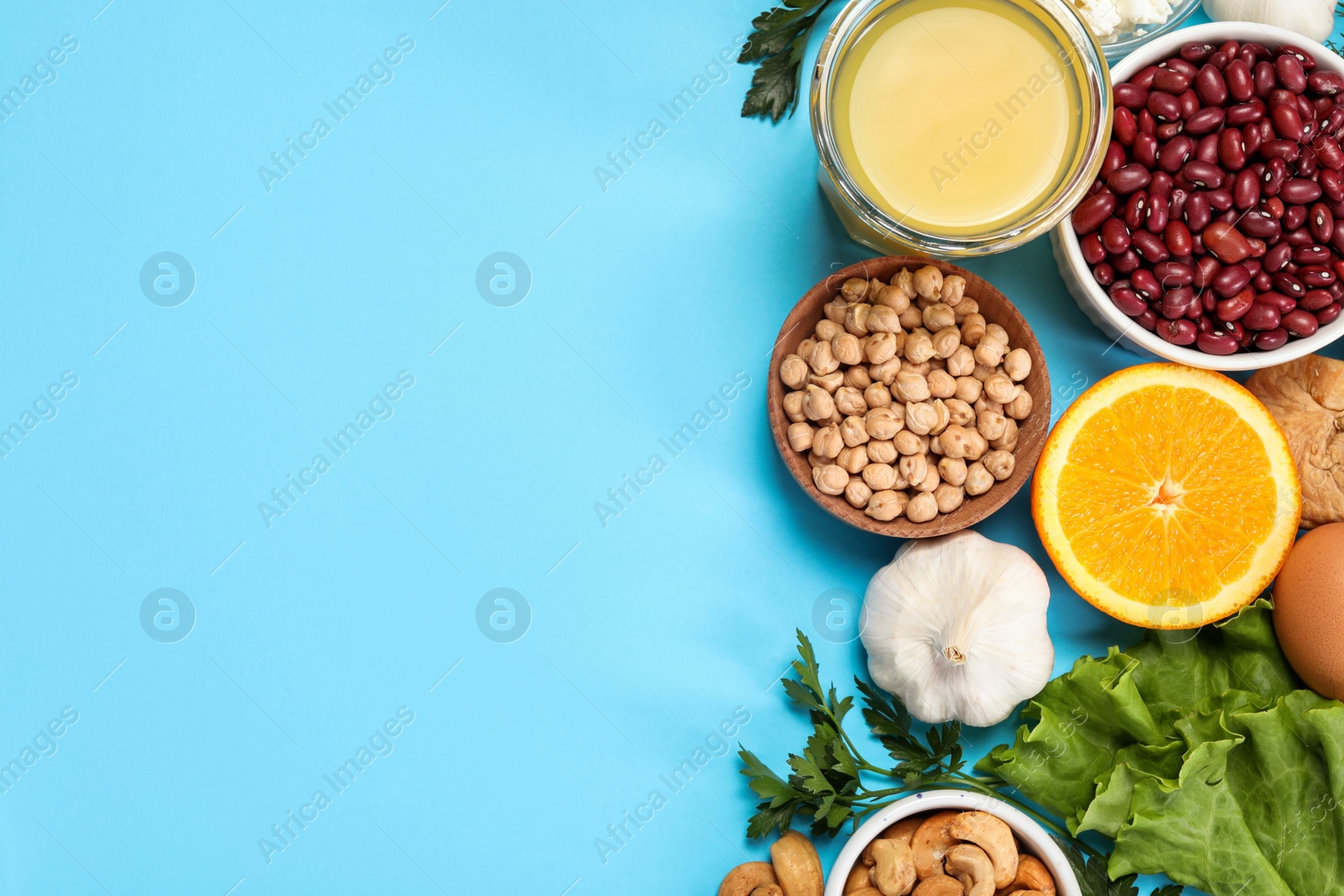 Photo of Food high in calcium. Flat lay composition with different products on light blue background, space for text