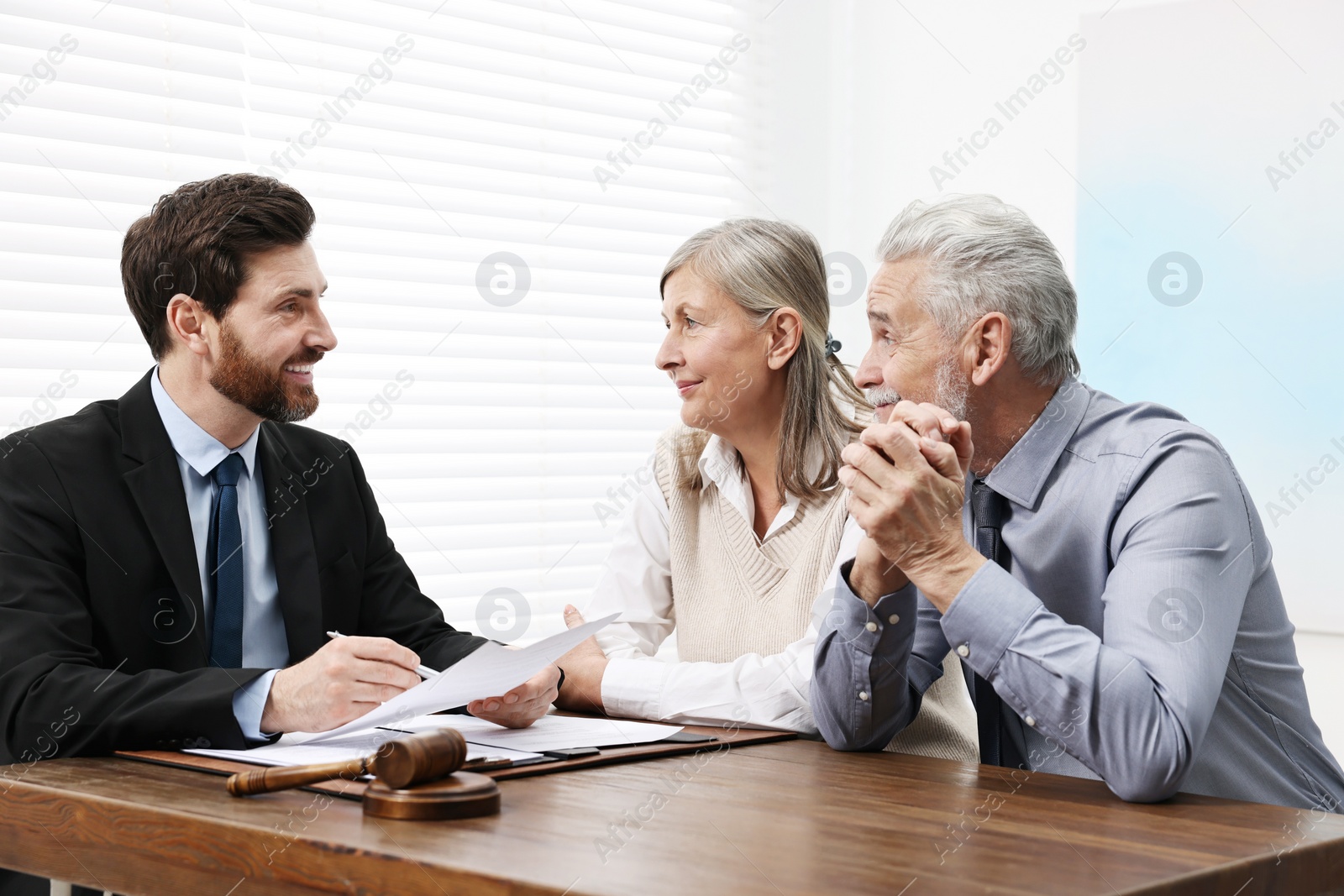 Photo of Senior couple having meeting with lawyer in office