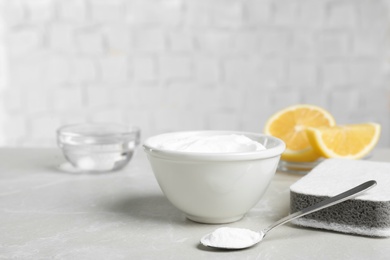 Photo of Baking soda and sponge on light grey table