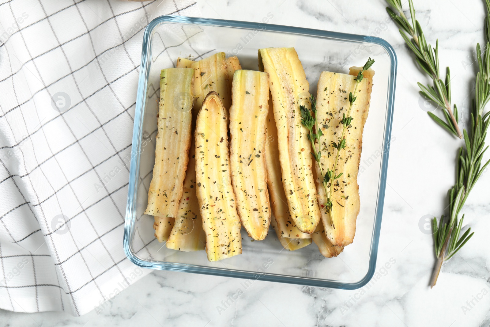 Photo of Raw cut white carrot in baking dish on white marble table, flat lay