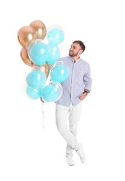 Young man with air balloons on white background