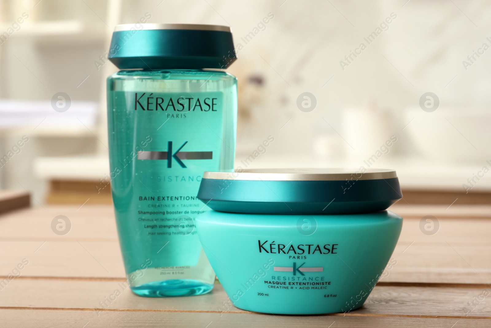 Photo of MYKOLAIV, UKRAINE - SEPTEMBER 07, 2021: Kerastase hair care cosmetic products on wooden table in bathroom