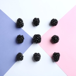 Photo of Fresh ripe blackberries on color background, flat lay