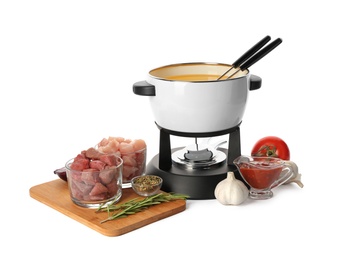 Photo of Composition with fondue pot and meat on white background