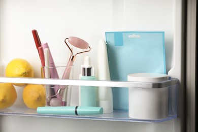 Photo of Different cosmetic products on shelf in refrigerator