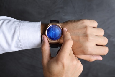 Image of Man using smart watch to check time, closeup