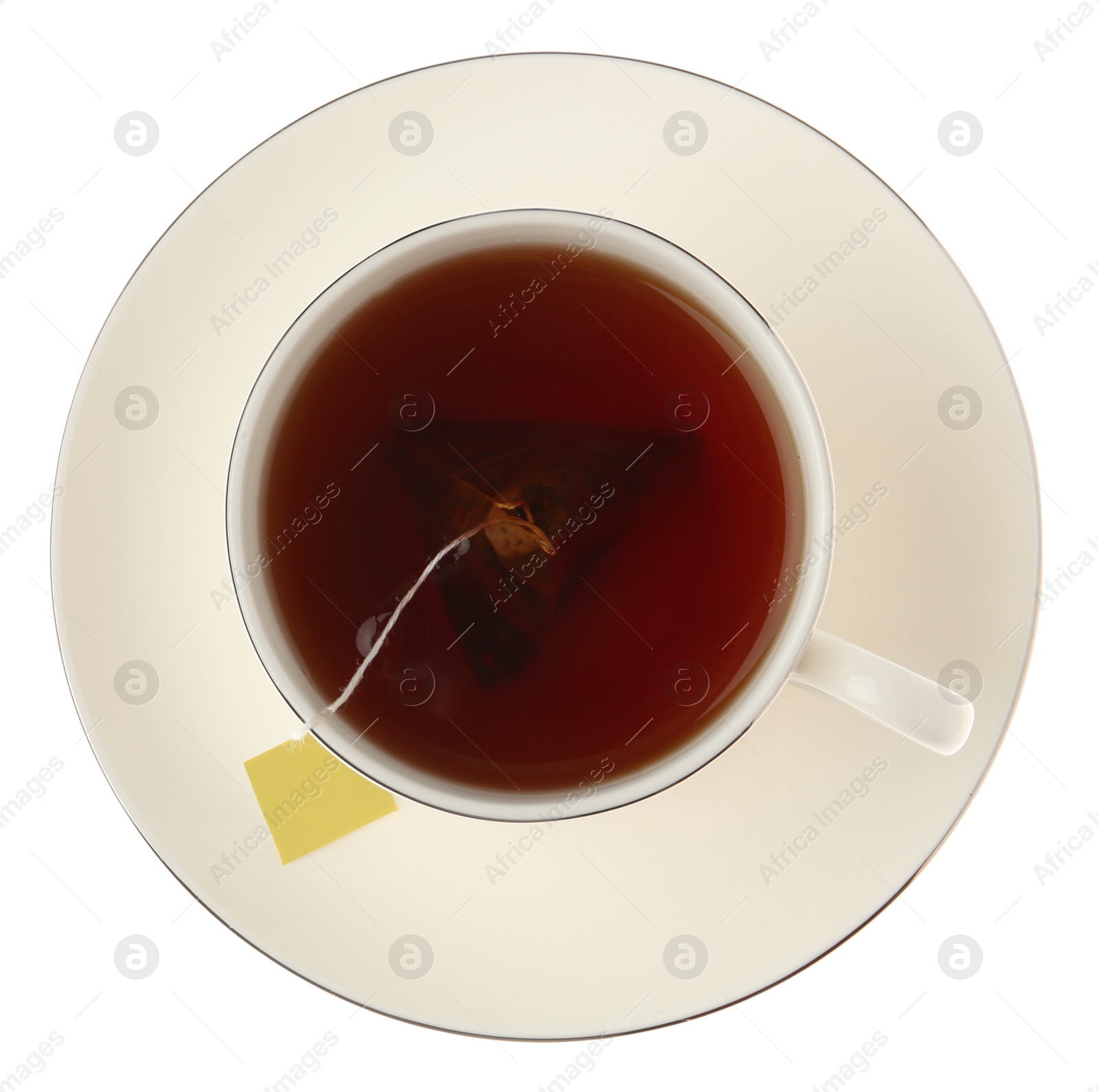 Photo of Tea bag in cup of hot water isolated on white, top view