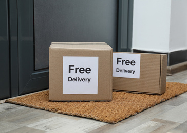Parcels with stickers Free Delivery on rug indoors. Courier service