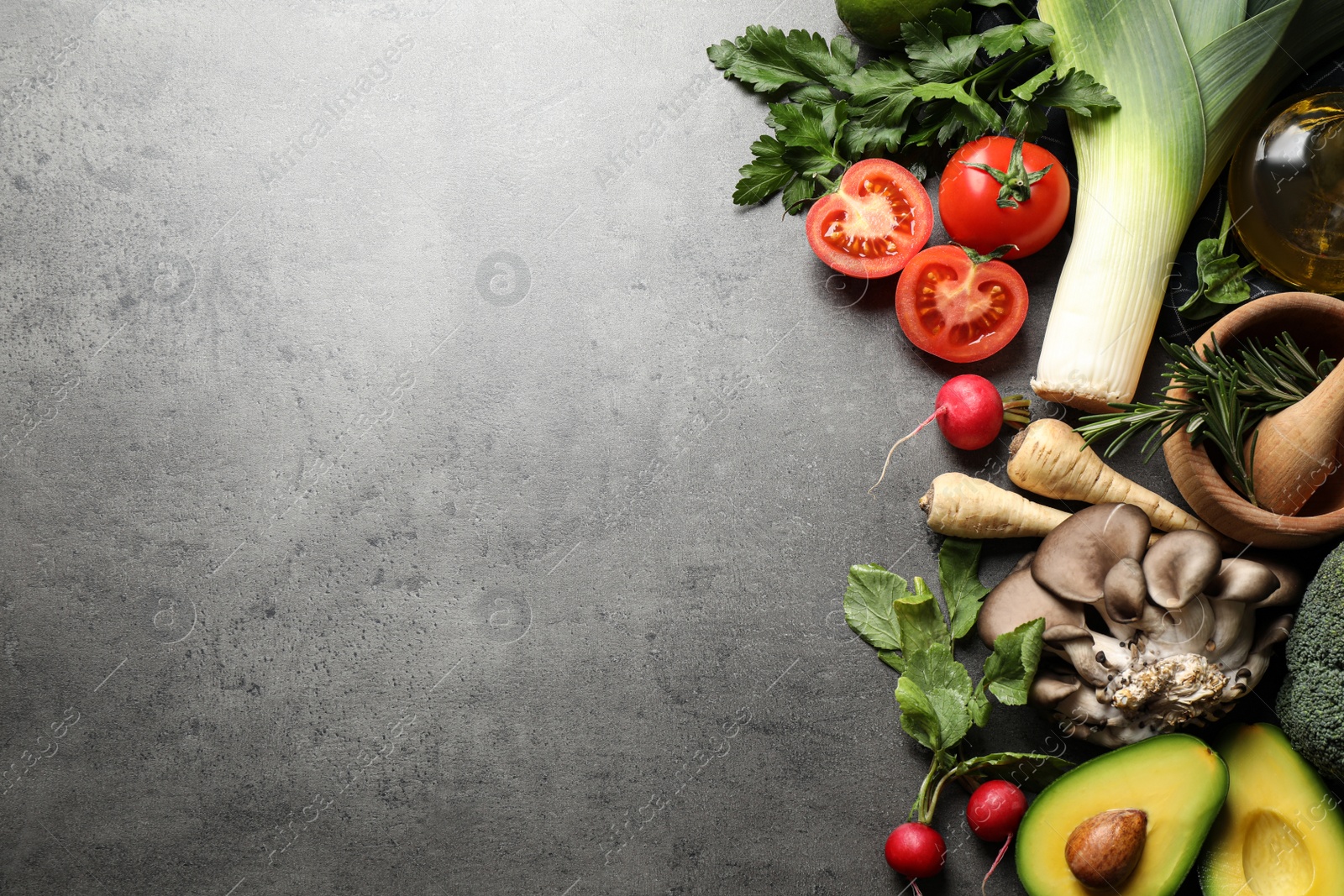 Photo of Flat lay composition with fresh products on grey table, space for text. Healthy cooking