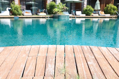 Photo of Outdoor swimming pool with wooden deck at resort