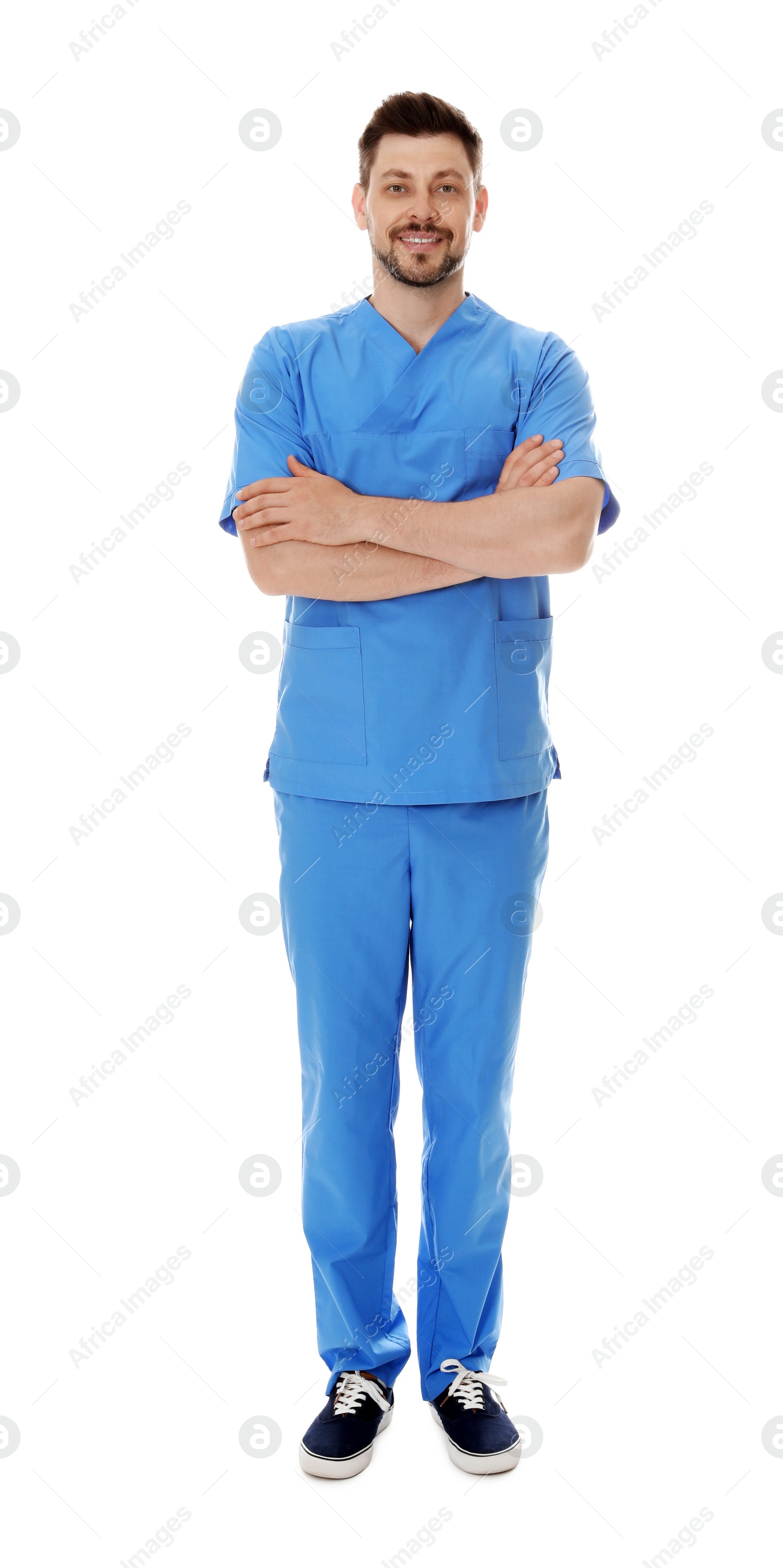 Photo of Full length portrait of smiling male doctor in scrubs isolated on white. Medical staff