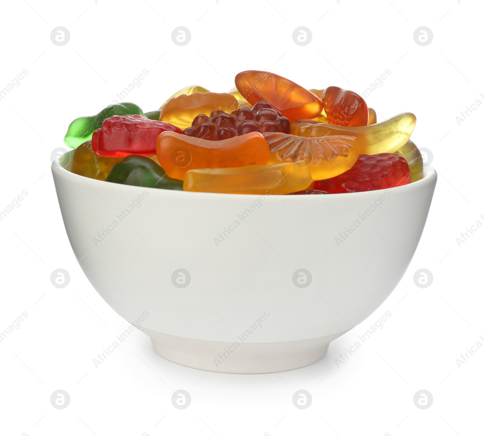 Photo of Tasty jelly fruit shaped candies in bowl on white background