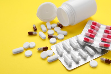 Photo of Different antidepressants on yellow background, closeup view