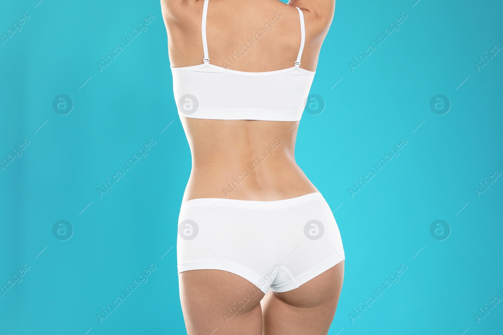Photo of Slim young woman with smooth gentle skin on color background. Beauty and body care concept