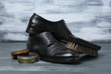 Photo of Footwear and shoes care accessories on grey table