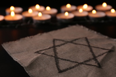 Photo of Fabric with star of David on black background. Holocaust memory day