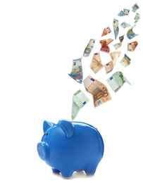 Image of Euro banknotes falling into blue piggy bank on white background