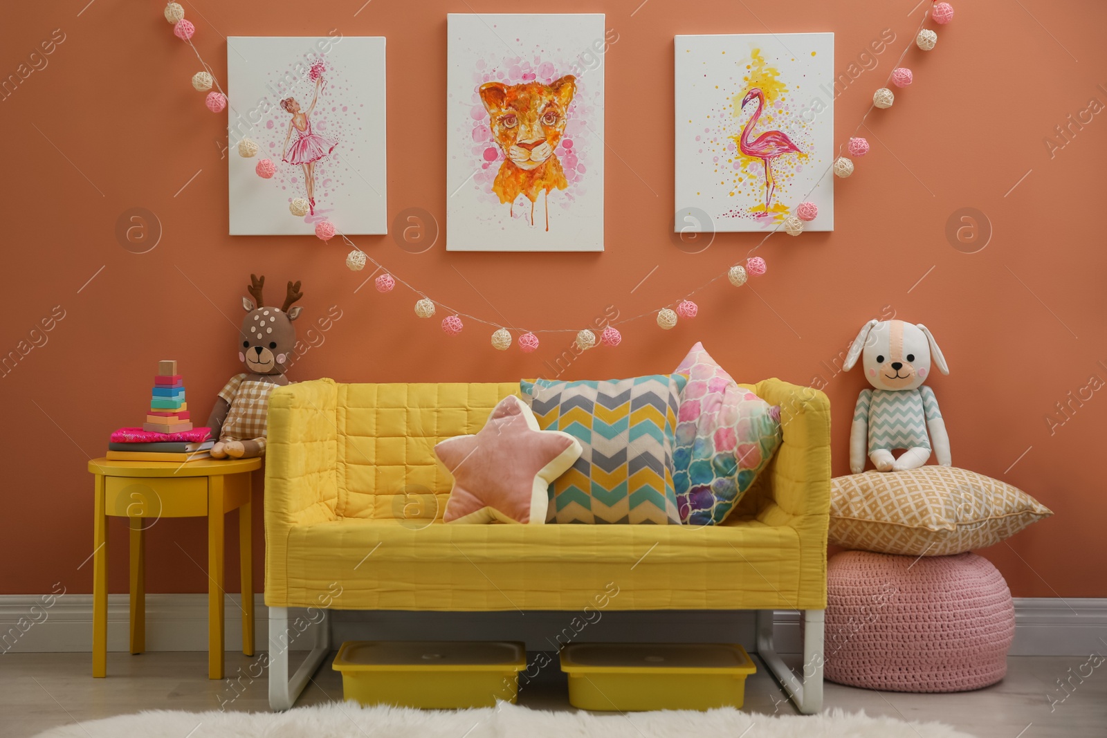 Photo of Cute pictures and comfortable sofa  in baby room interior