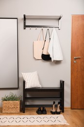 Modern hallway interior with shoe rack and mirror