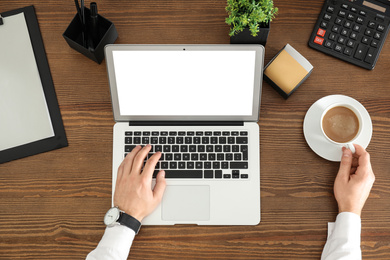 Image of Man using modern computer at table, top view. Space for design