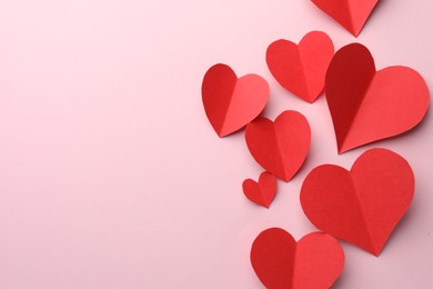 Photo of Paper hearts on pink background, flat lay. Space for text