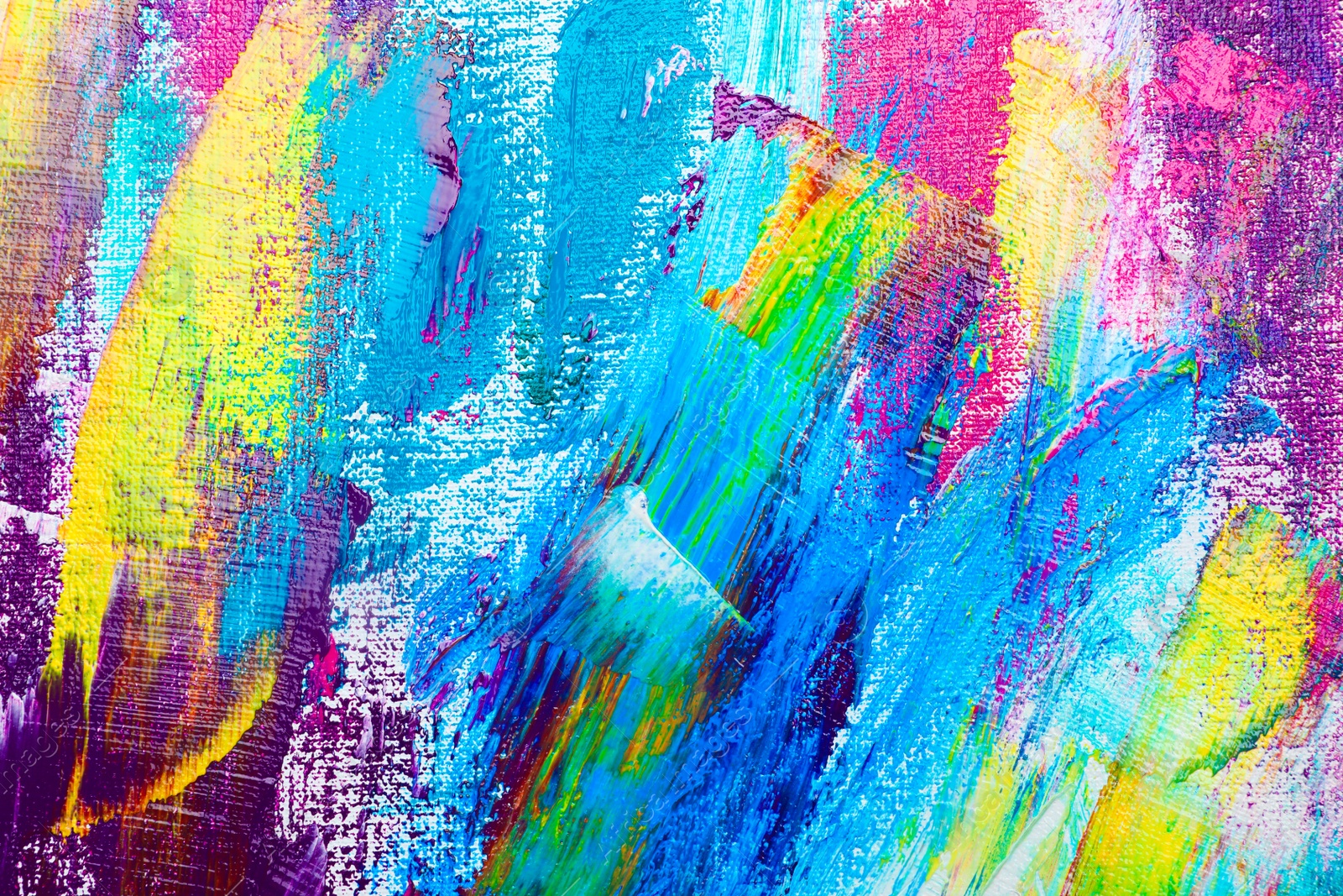 Photo of Strokes of colorful acrylic paints on canvas, closeup