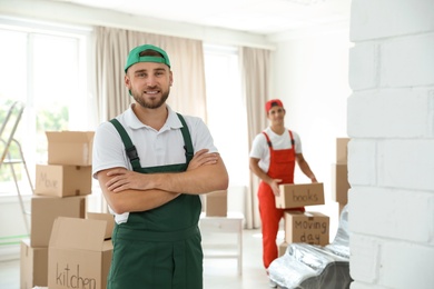 Portrait of male mover in uniform indoors