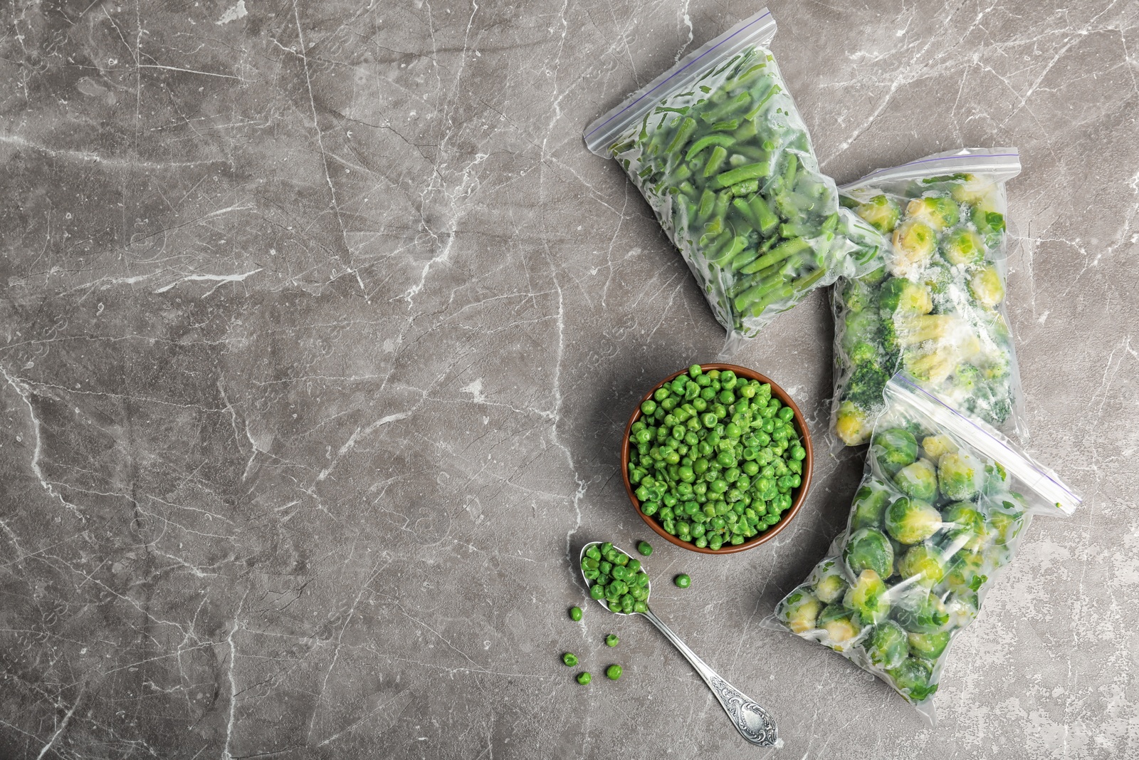 Photo of Different frozen vegetables on table, top view