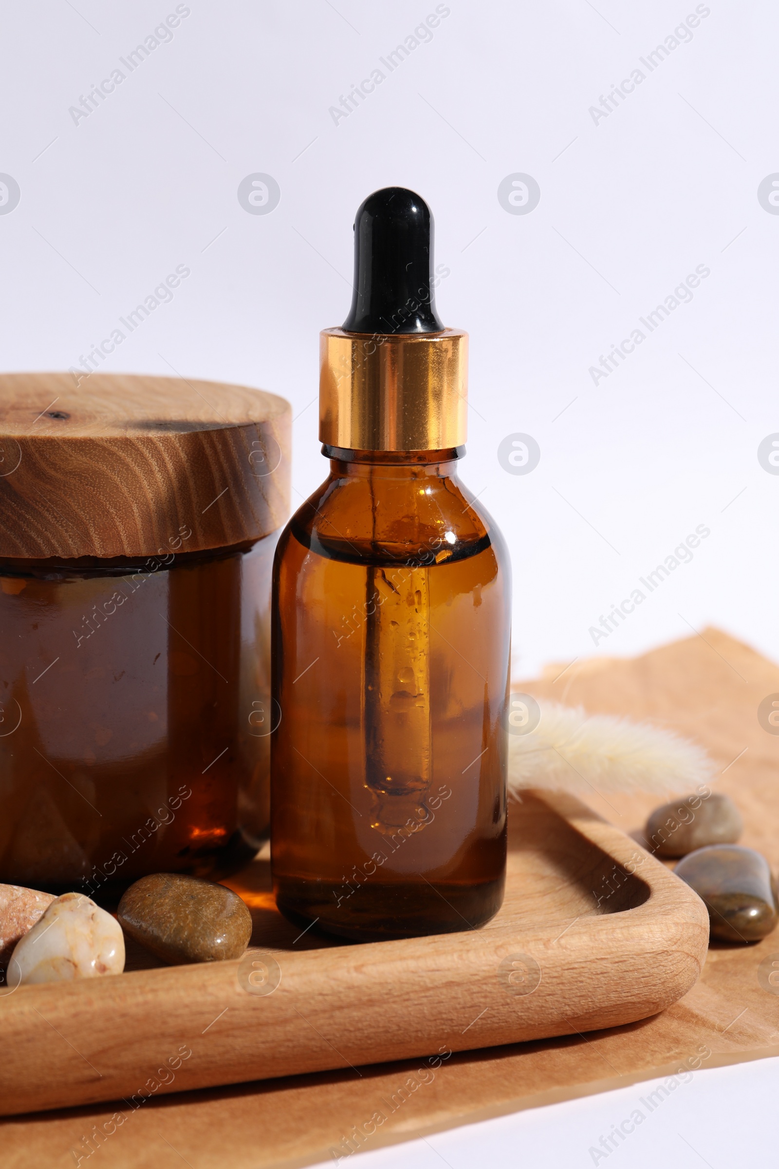 Photo of Composition with bottle of cosmetic serum on white background, closeup