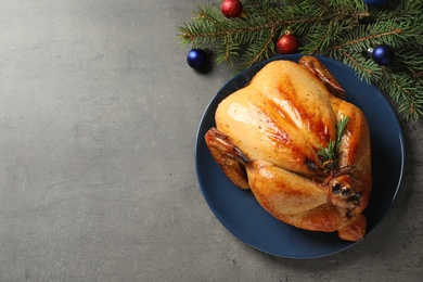 Photo of Platter of cooked turkey with Christmas decoration on grey background, flat lay. Space for text