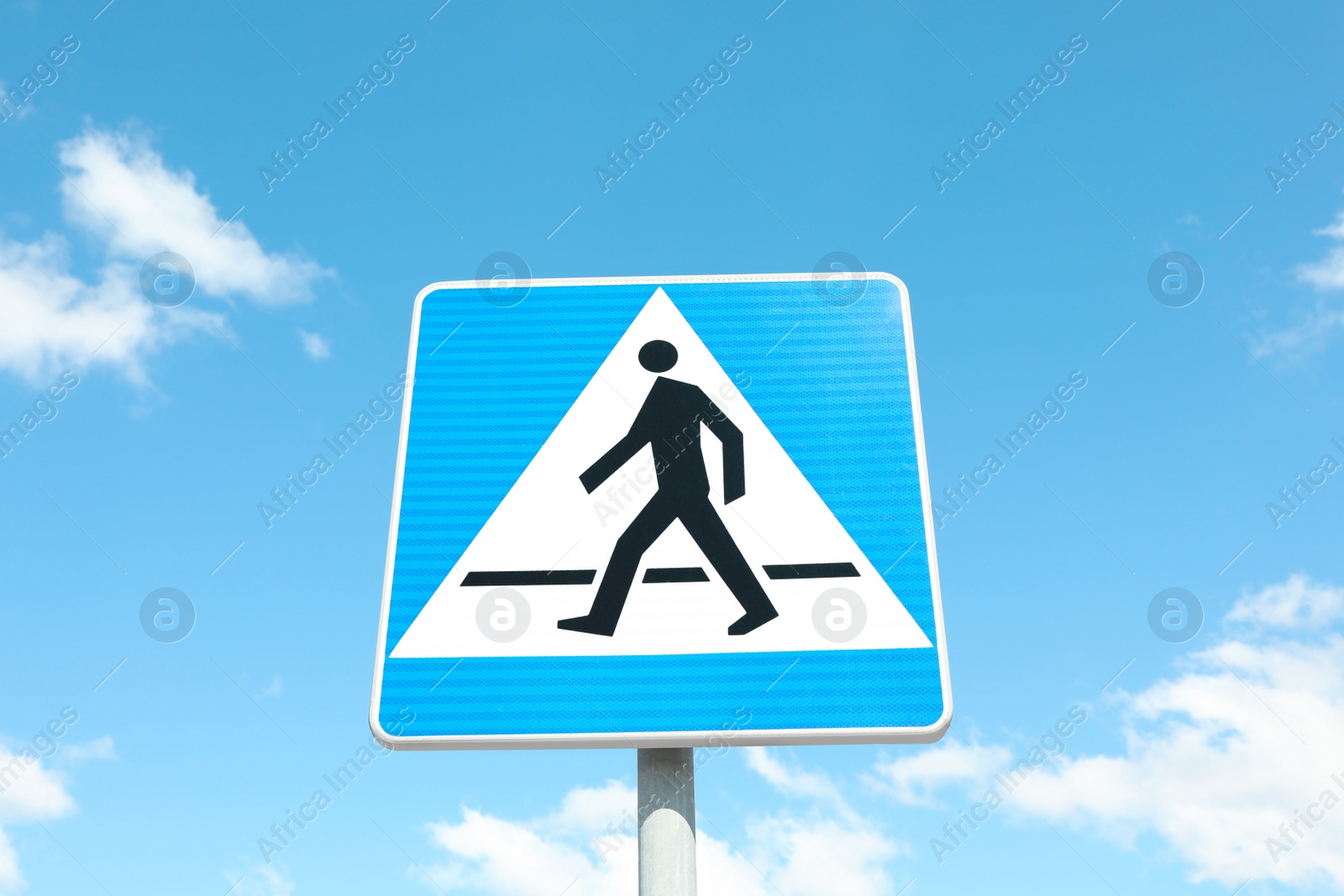 Photo of Traffic sign Pedestrian Crossing against blue sky, low angle view