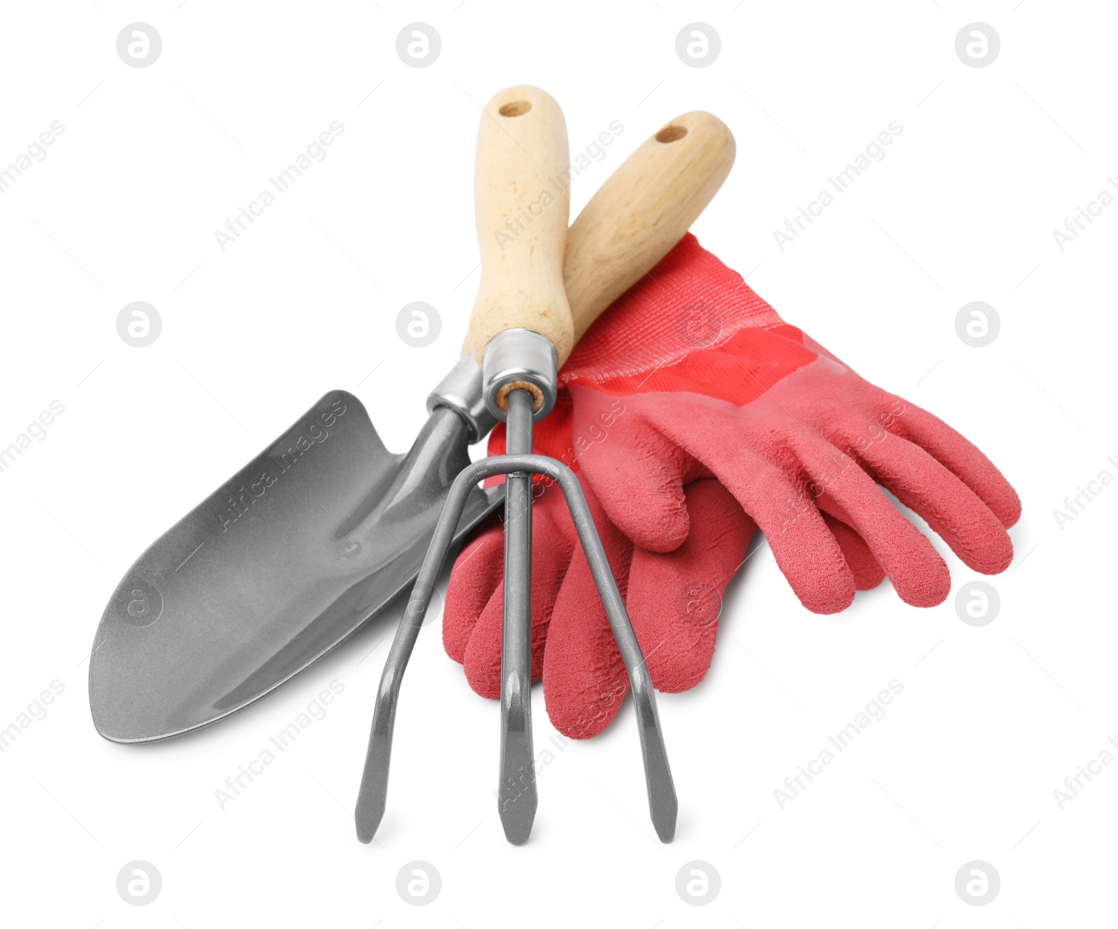 Photo of Gardening gloves, trowel and rake isolated on white