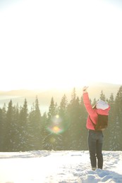 Photo of Young woman enjoying beautiful nature. Winter vacation
