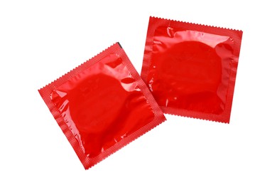 Photo of Condom packages isolated on white, top view. Safe sex