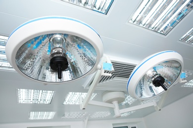 Photo of Powerful surgical lamps in modern operating room