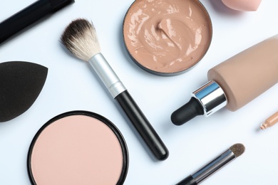 Photo of Flat lay composition with skin foundation, powder and beauty accessories on white background