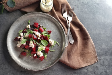 Plate with delicious beet salad on table, top view