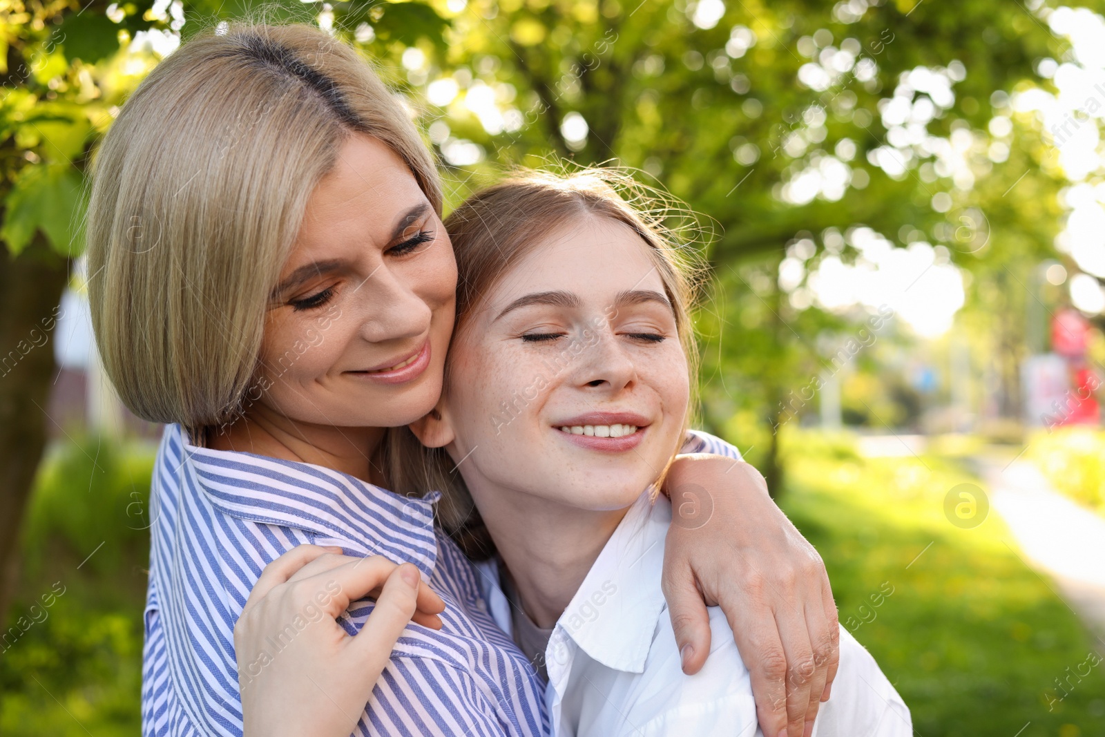 Photo of Happy mother with her daughter spending time together in park on sunny day