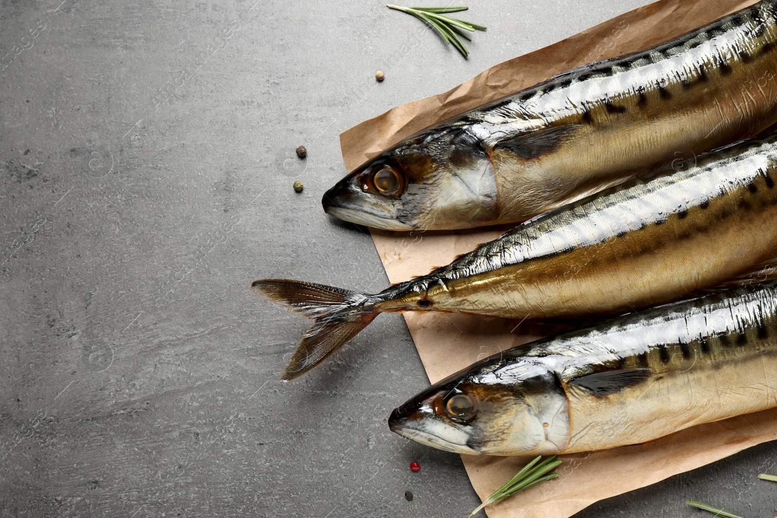 Photo of Tasty smoked mackerel fish on grey table