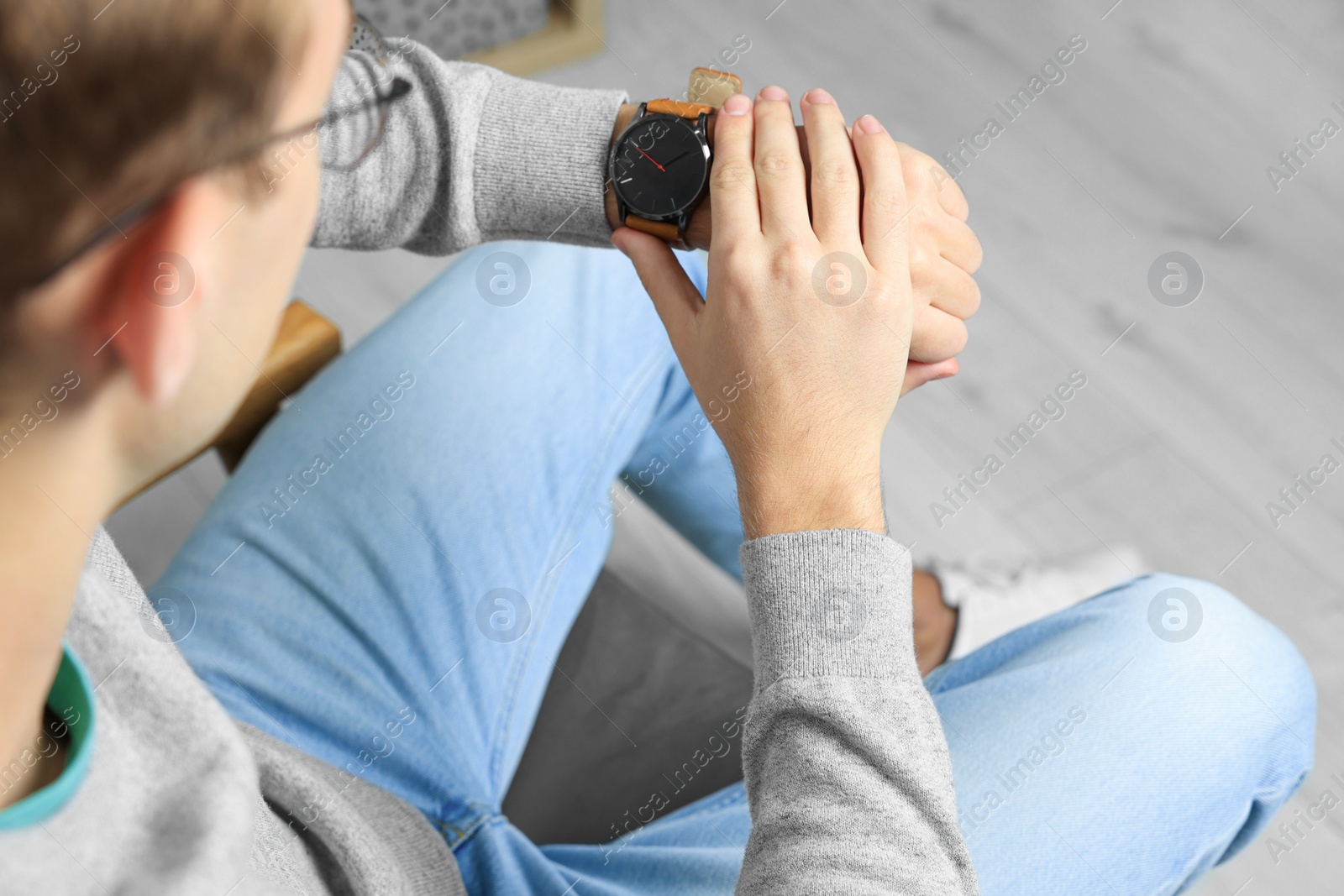 Photo of Man checking time in room, closeup. Being late