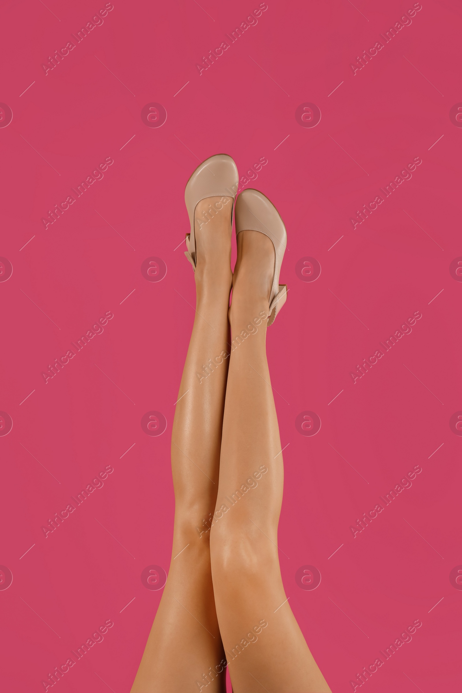 Photo of Woman wearing stylish shoes on pink background, closeup