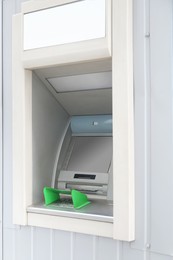 Modern automated cash machine with screen outdoors