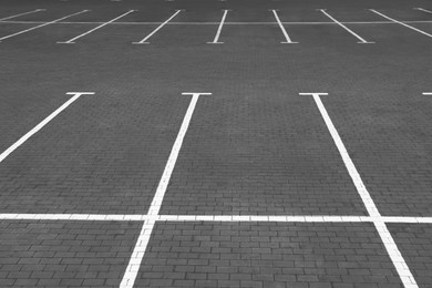 Photo of Empty car parking lots with white marking lines outdoors