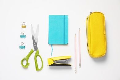 Photo of Composition with scissors and school stationery on white background, top view