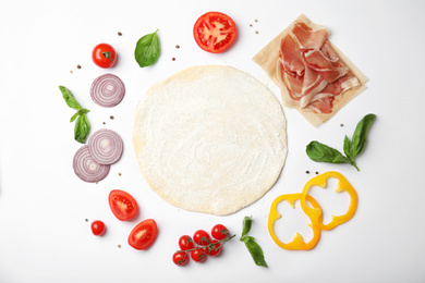 Photo of Flat lay composition with dough and fresh ingredients for pizza on white background